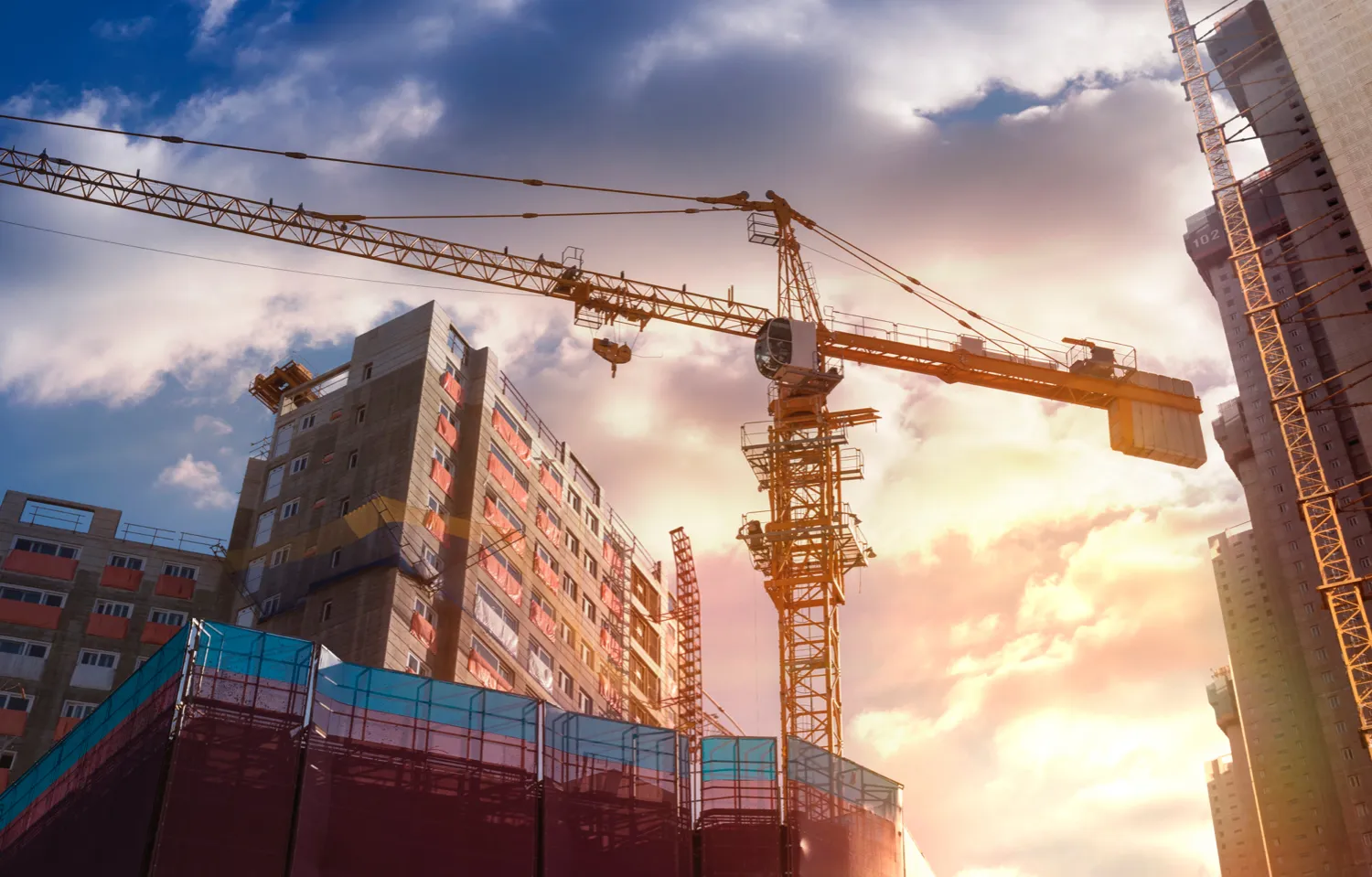 A construction site featuring a tower crane and buildings